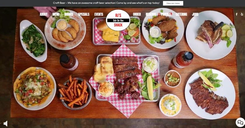 RJ's Bob-Be-Que Shack website featuring a table full of barbecue dishes.