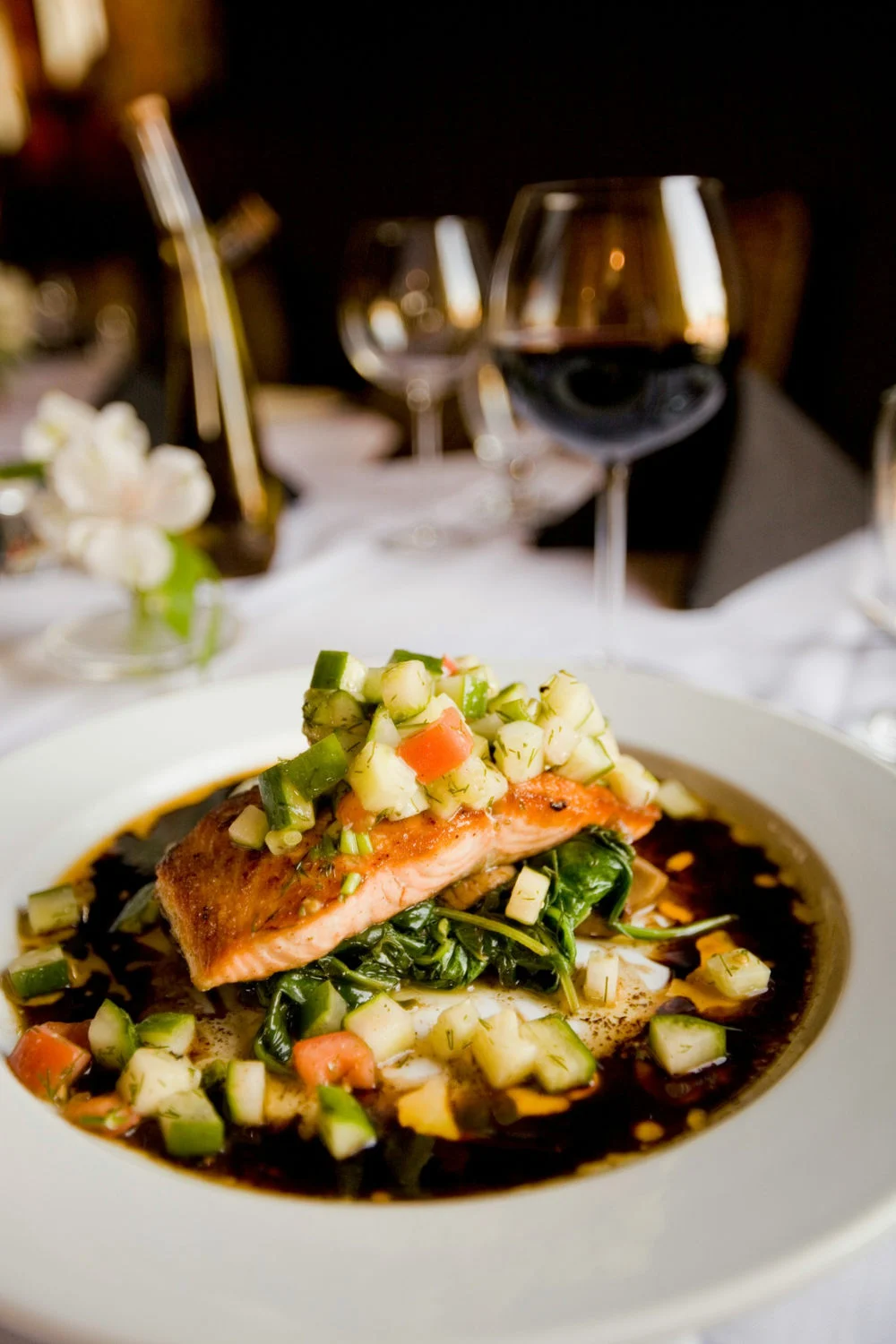 Functional food trends 2026 illustrated by a restaurant salmon entrée with fresh vegetables and leafy greens